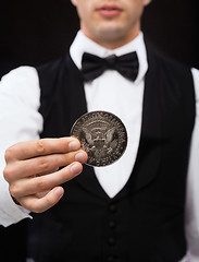 Image showing dealer holding half dollar coin