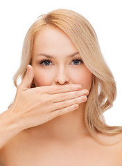 Image showing beautiful woman covering her mouth