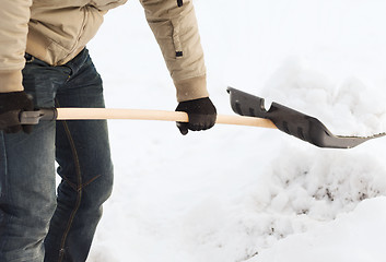 Image showing closeup of man shoveling snow from driveway