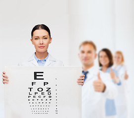 Image showing calm female doctor with eye chart