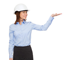 Image showing young smiling businesswoman in white helmet