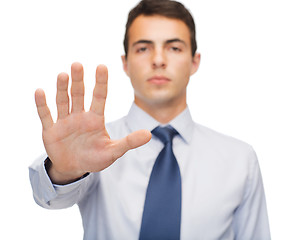 Image showing attractive buisnessman making stop gesture