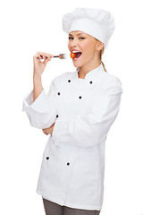 Image showing female chef, cook or baker with fork and tomato