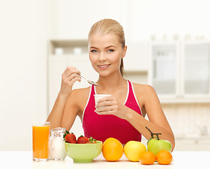 Image showing young woman eating healthy breakfast