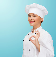 Image showing smiling female chef showing ok hand sign