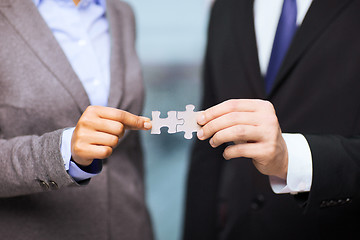 Image showing businessman and businesswoman with puzzle pieces