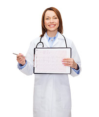 Image showing doctor with stethoscope, clipboard and cardiogram