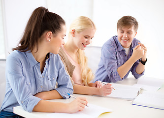 Image showing smiling students with notebooks at school