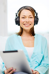 Image showing smiling woman with tablet pc and headphones