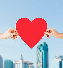 Image showing couple hands holding red heart