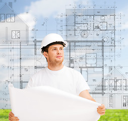 Image showing male architect looking at blueprint