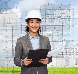 Image showing businesswoman in white helmet with clipboard