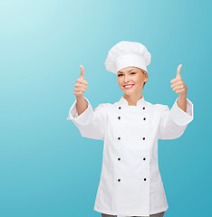 Image showing smiling female chef showing thumbs up