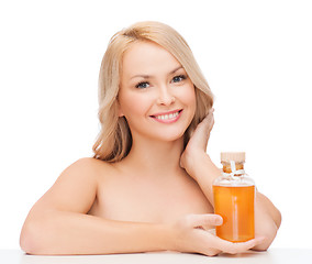 Image showing happy woman with oil bottle