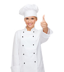 Image showing smiling female chef showing thumbs up