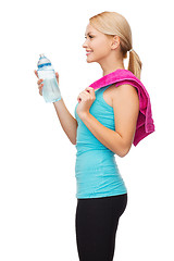 Image showing sporty woman with towel and water bottle