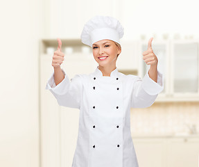 Image showing smiling female chef showing thumbs up