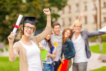 Image showing smiling teenage girl in corner-cap with diploma