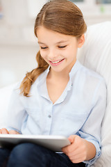 Image showing smiling girl with tablet computer at home