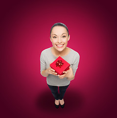 Image showing smiling asian woman with red gift box