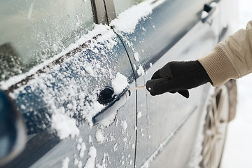 Image showing closeup of man hand opening car with key