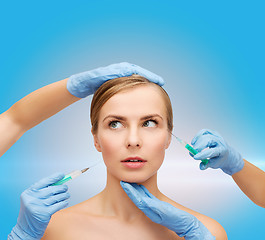 Image showing woman face and beautician hands with syringe