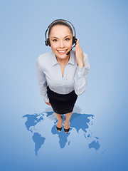 Image showing friendly female helpline operator with headphones