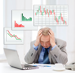 Image showing upset older businessman with laptop in office