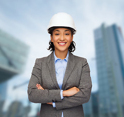 Image showing businesswoman in white helmet with crossed arms