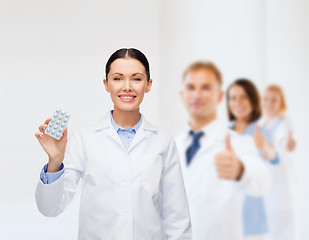 Image showing smiling female doctor with pills