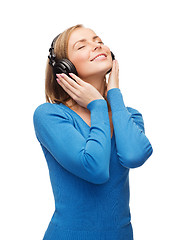 Image showing smiling young woman with headphones