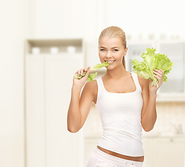 Image showing woman biting lettuce