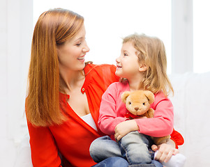 Image showing happy mother and child with teddy bear at home