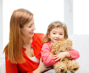 Image showing happy mother and child with teddy bear at home