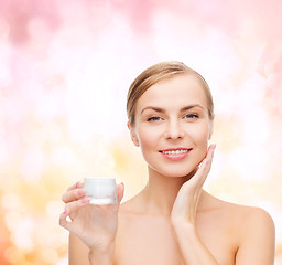 Image showing woman applying cream on her skin