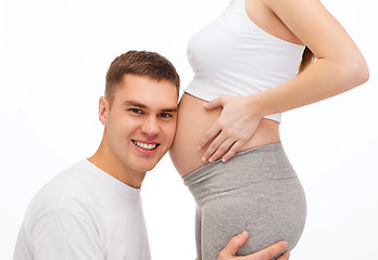 Image showing happy father listening belly of his pregnant wife