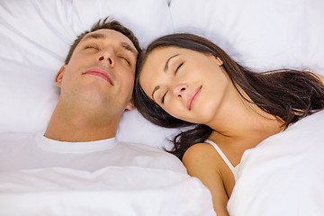 Image showing happy couple sleeping in bed