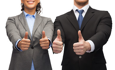 Image showing businessman and businesswoman showing thumbs up