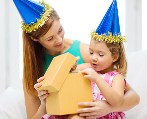 Image showing mother and daughter in blue hats with favor horns