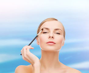 Image showing beautiful woman with makeup brush