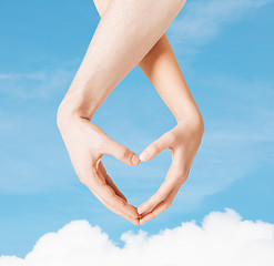 Image showing woman and man hands showing heart shape