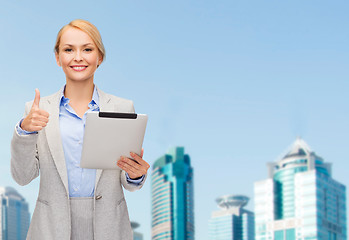 Image showing smiling woman with tablet pc showing thumbs up