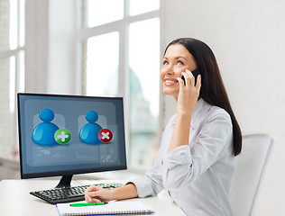 Image showing smiling businesswoman or student with smartphone