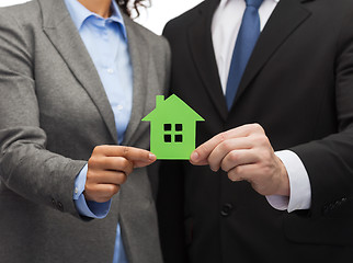 Image showing businessman and businesswoman holding green house