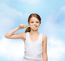 Image showing girl in blank white shirt brushing her teeth