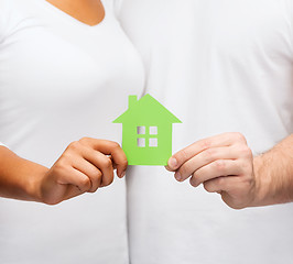 Image showing couple hands holding green house