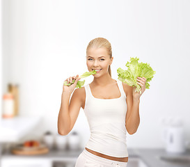Image showing woman biting lettuce