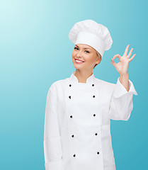 Image showing smiling female chef showing ok hand sign