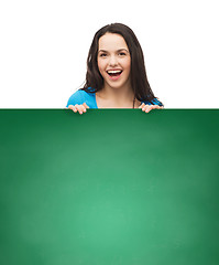 Image showing smiling young girl with blank white board