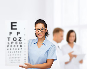 Image showing female doctor or nurse with white blank board